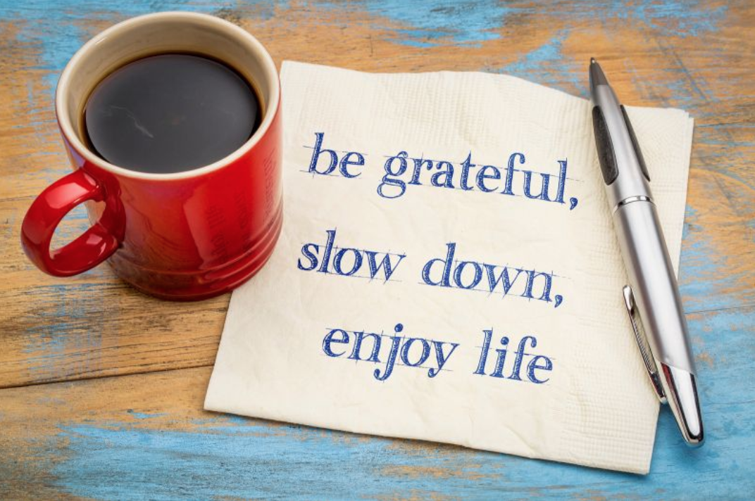 Be Grateful, Slow Down, Enjoy Life note with pen and coffee cup